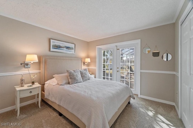 carpeted bedroom featuring access to exterior, ornamental molding, french doors, and a textured ceiling