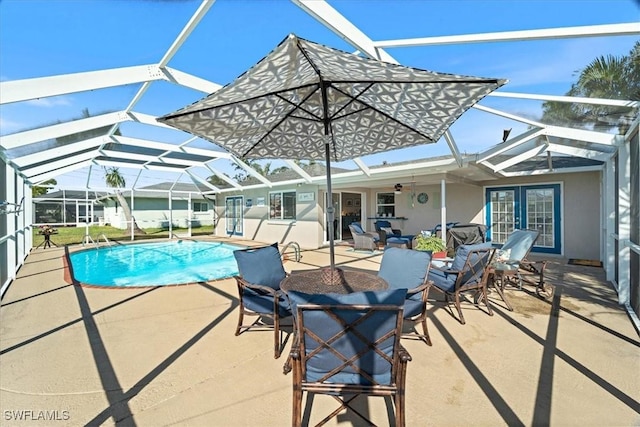 view of swimming pool with a lanai and a patio area