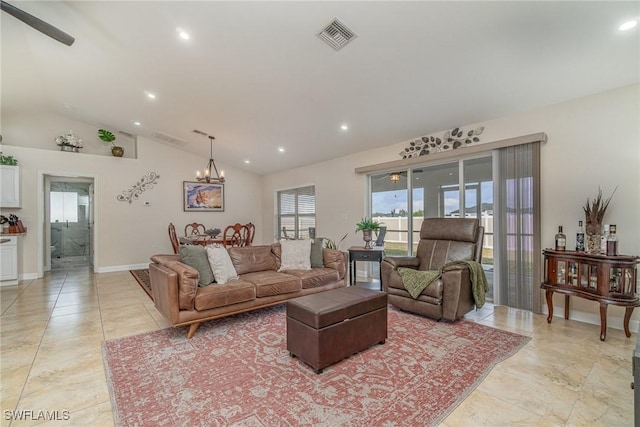 living room with lofted ceiling and a notable chandelier