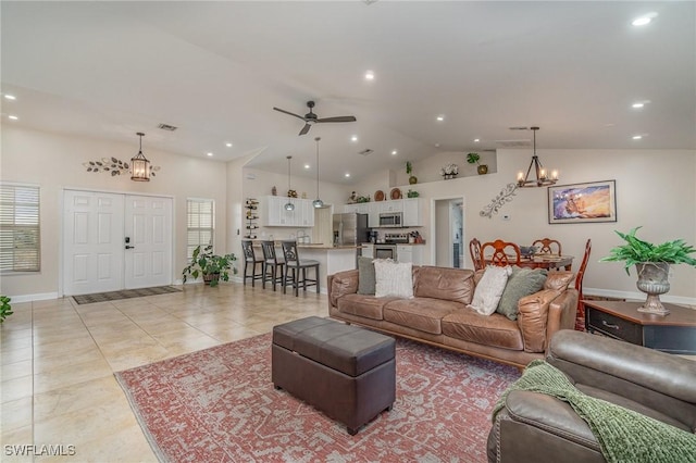 living room featuring high vaulted ceiling, light tile patterned floors, and ceiling fan with notable chandelier