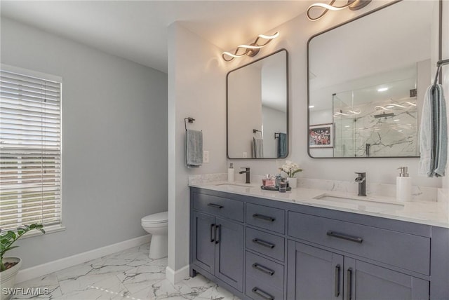 bathroom featuring toilet, a shower with shower door, and vanity