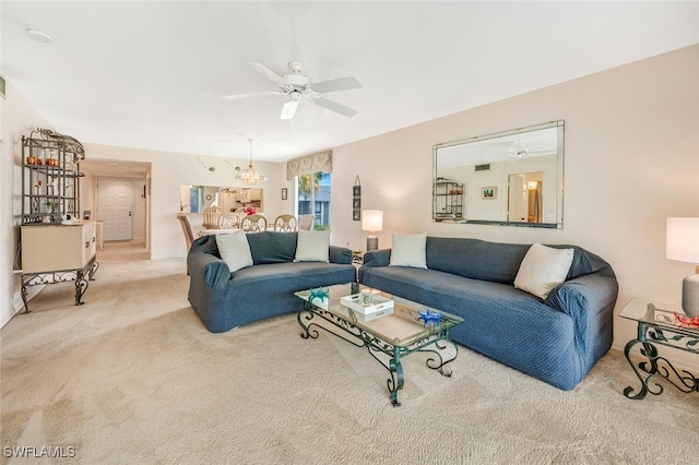 carpeted living room with ceiling fan