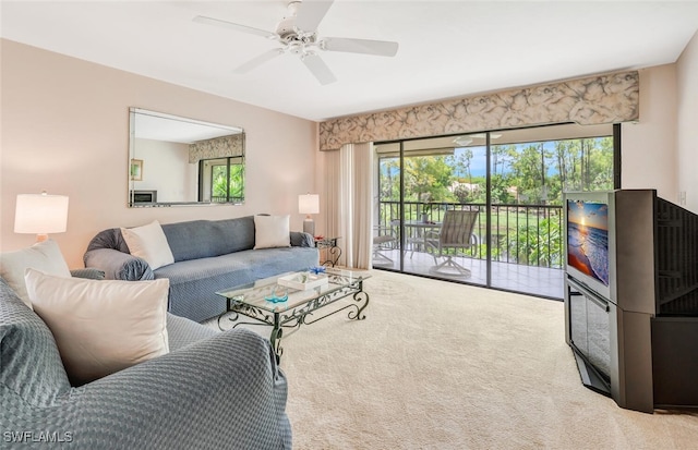 carpeted living room featuring ceiling fan and a healthy amount of sunlight