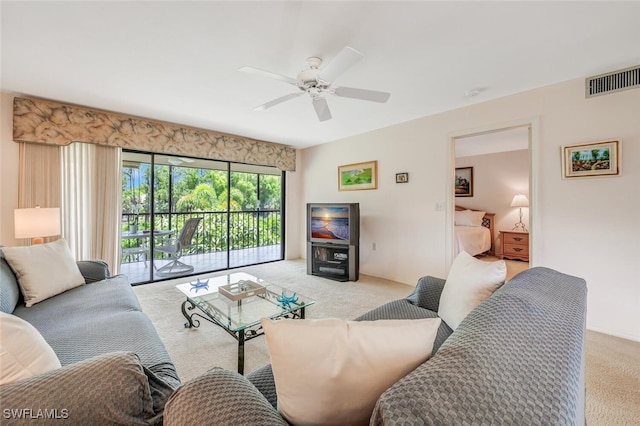 carpeted living room with ceiling fan