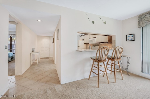 hallway featuring light tile patterned floors