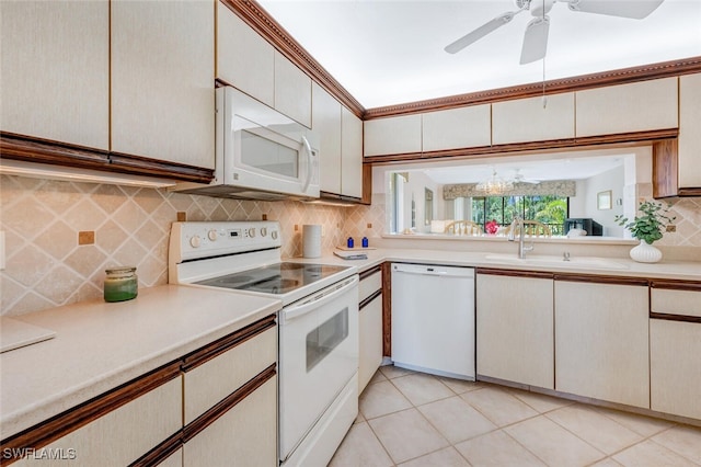 kitchen featuring light tile patterned floors, backsplash, white appliances, and white cabinetry