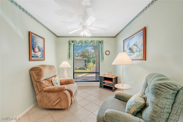 sitting room with ceiling fan and light tile patterned flooring