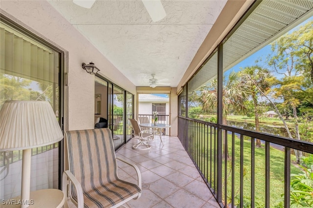 sunroom / solarium featuring ceiling fan