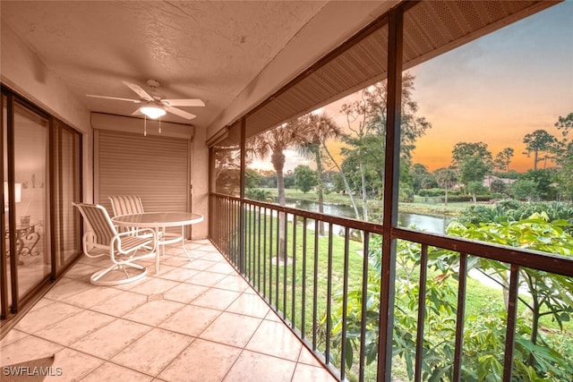 1207 Commonwealth Cir Unit B201, Naples, FL 34116 - balcony at dusk with a water view and a ceiling fan