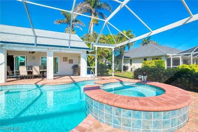 view of swimming pool with an in ground hot tub, a grill, a patio area, and glass enclosure