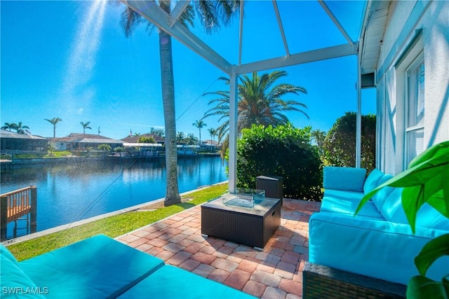 view of patio featuring a water view and an outdoor living space with a fire pit