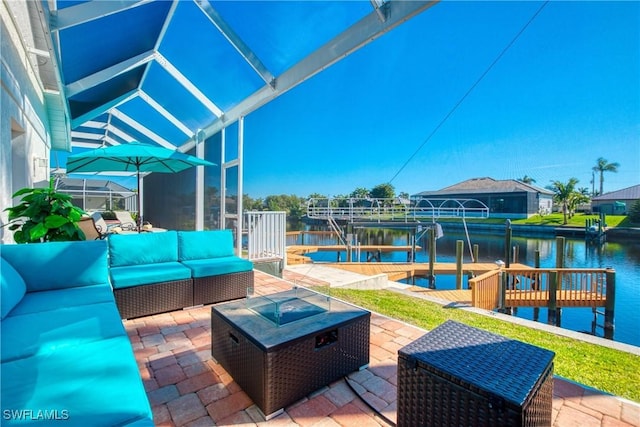 view of patio featuring a water view, an outdoor living space with a fire pit, and a boat dock