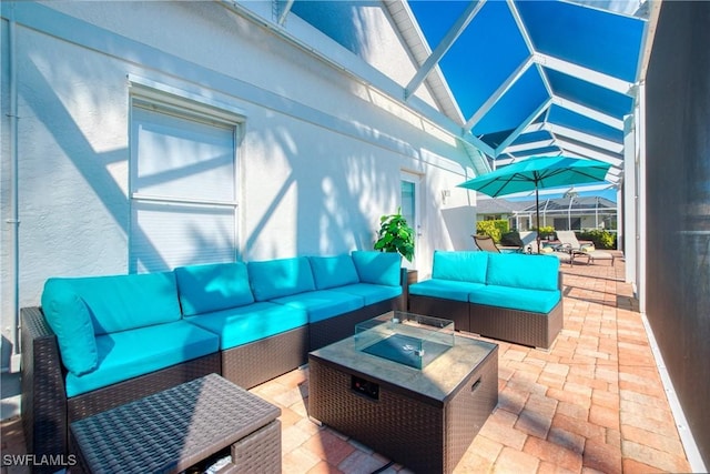 view of patio with an outdoor living space with a fire pit