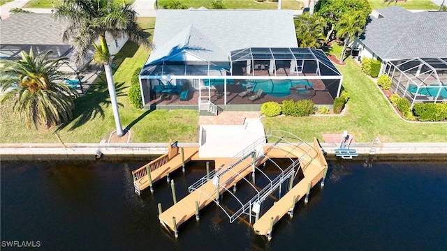 dock area featuring a yard, a water view, and glass enclosure