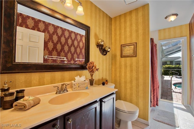 bathroom with tile patterned flooring, vanity, and toilet