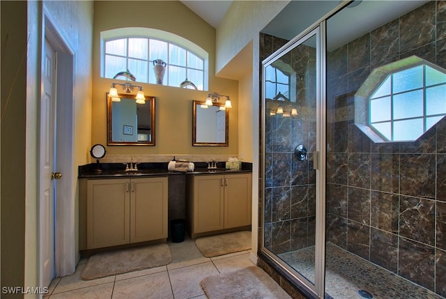 bathroom with vanity, tile patterned flooring, plenty of natural light, and walk in shower