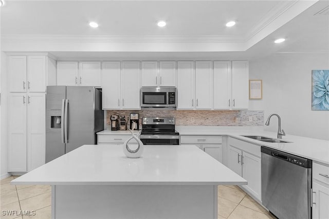 kitchen with white cabinetry, stainless steel appliances, sink, backsplash, and light tile patterned floors