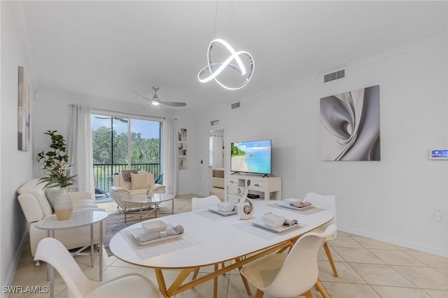 tiled dining space featuring ceiling fan and crown molding