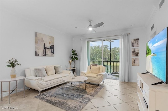 tiled living room with ceiling fan and crown molding