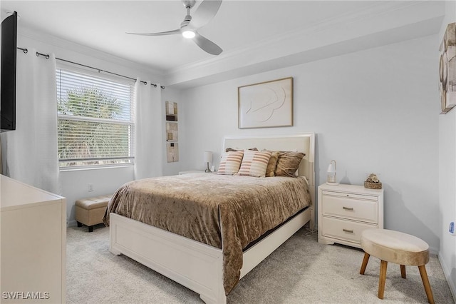 carpeted bedroom featuring ceiling fan and crown molding