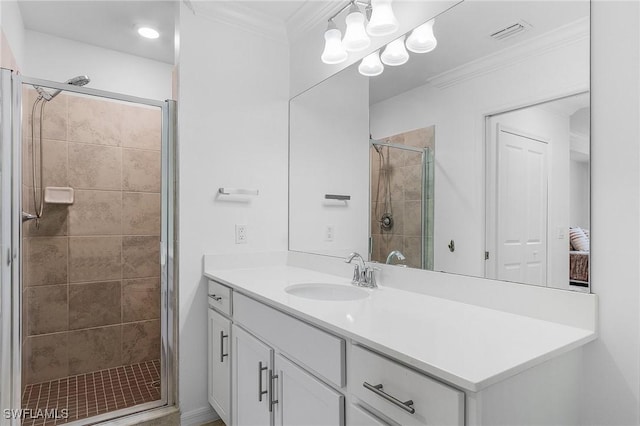 bathroom featuring vanity, a shower with door, and ornamental molding