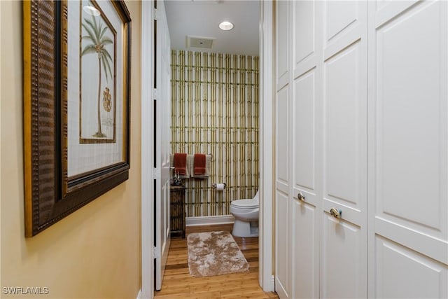 bathroom featuring toilet and hardwood / wood-style flooring