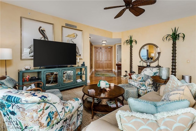 living room featuring ceiling fan and hardwood / wood-style floors