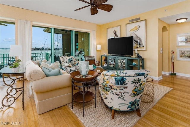 living room with ceiling fan and hardwood / wood-style flooring