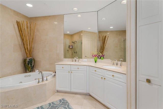 bathroom featuring tile walls, tile patterned flooring, vanity, and plus walk in shower