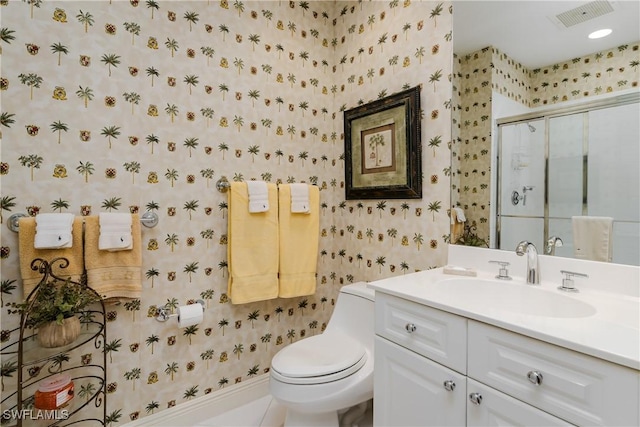 bathroom with tile patterned floors, toilet, walk in shower, and vanity