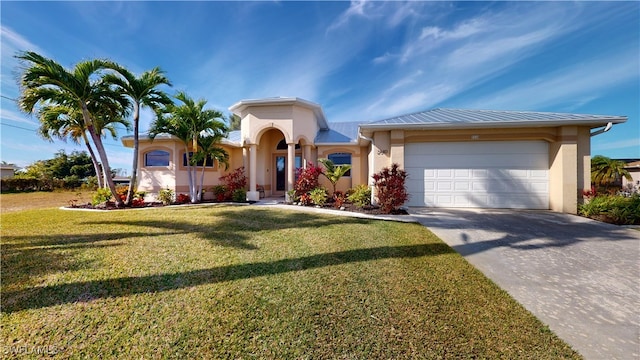 view of front of house with a garage and a front lawn