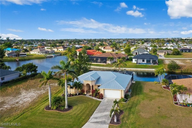 birds eye view of property featuring a water view and a residential view