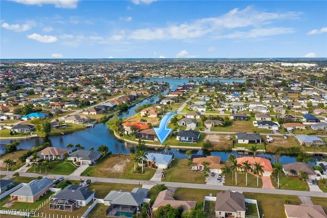 bird's eye view featuring a water view and a residential view