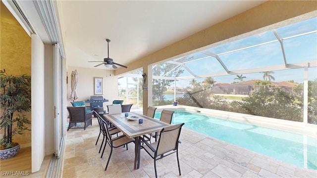 view of patio / terrace with ceiling fan, outdoor dining space, a lanai, and an outdoor pool