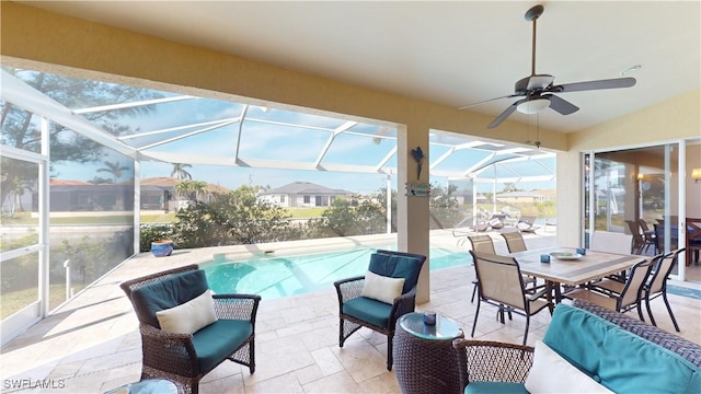 exterior space with glass enclosure, a patio area, and ceiling fan