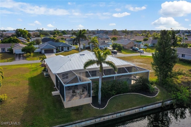 drone / aerial view with a water view and a residential view