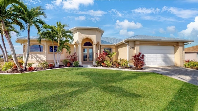 view of front of house with concrete driveway, an attached garage, french doors, a front yard, and stucco siding