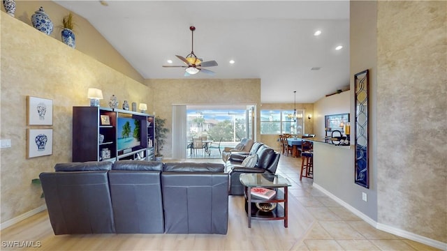 tiled living area with high vaulted ceiling and recessed lighting