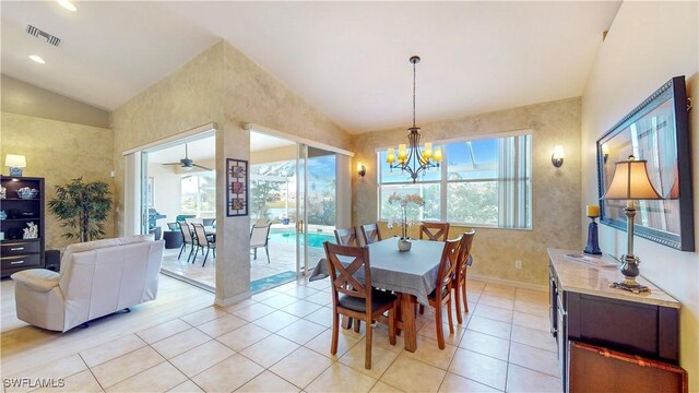 dining room with high vaulted ceiling, light tile patterned flooring, a notable chandelier, visible vents, and baseboards