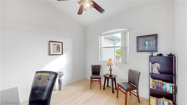 living area featuring a ceiling fan and wood finished floors