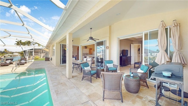 view of patio featuring an outdoor pool, a lanai, outdoor lounge area, and ceiling fan