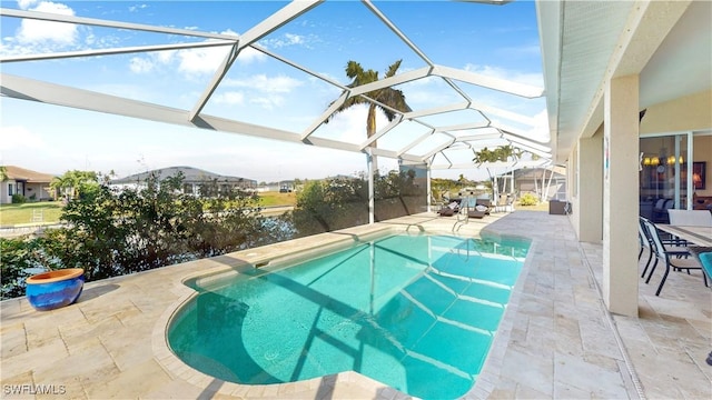 outdoor pool with glass enclosure and a patio