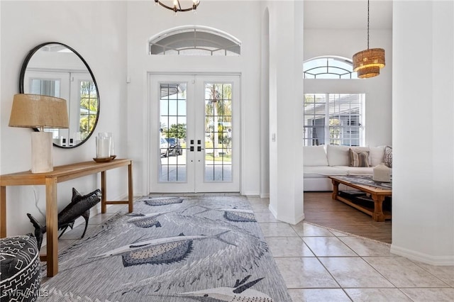 doorway with light tile patterned floors and french doors