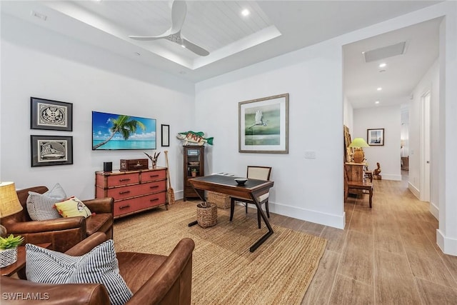 office with ceiling fan and a tray ceiling