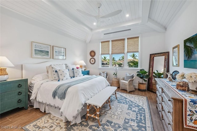 bedroom with ceiling fan, beamed ceiling, wooden ceiling, and hardwood / wood-style flooring