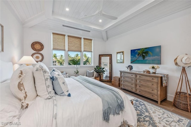 bedroom with ceiling fan, wooden ceiling, hardwood / wood-style floors, and beam ceiling