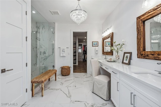 bathroom with an enclosed shower, vanity, and a notable chandelier