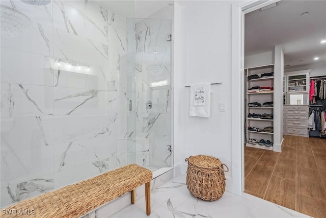 bathroom featuring a shower with door