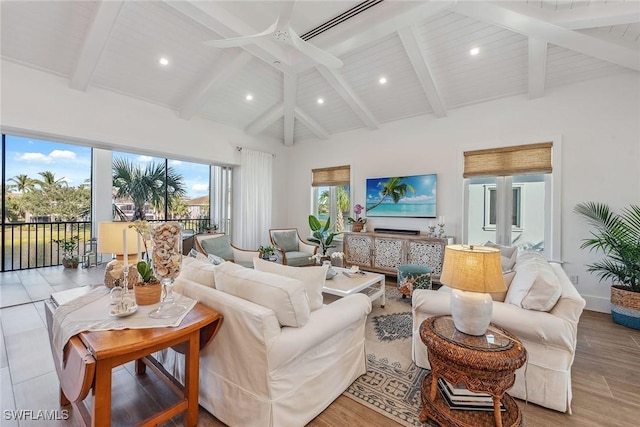 living room with light wood-type flooring, ceiling fan, and beam ceiling