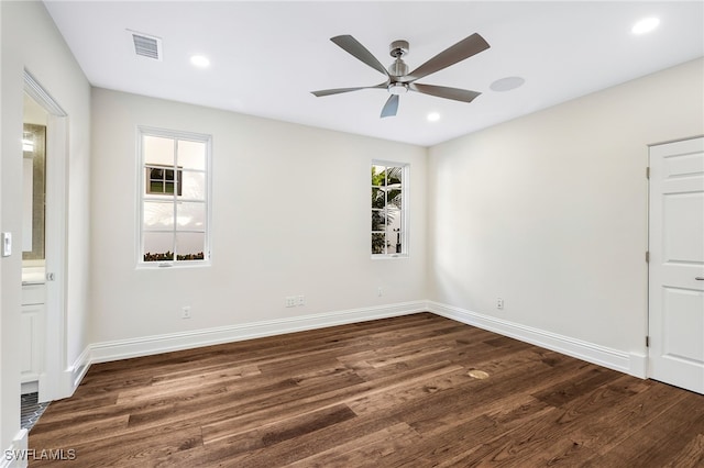 spare room with ceiling fan, dark hardwood / wood-style flooring, and a healthy amount of sunlight